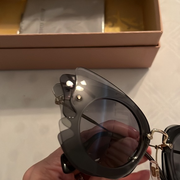 Sunglasses, has light tone of grey and black. New box, case, cleanse cloth NWOT
